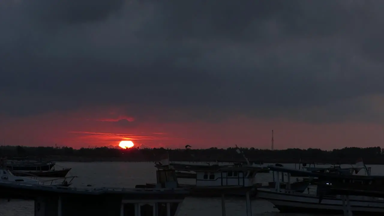 sunset or sunrise against the foreground of a fishing boat