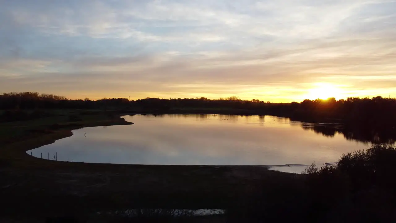 Peaceful lake landscape with golden sunset aerial drone view