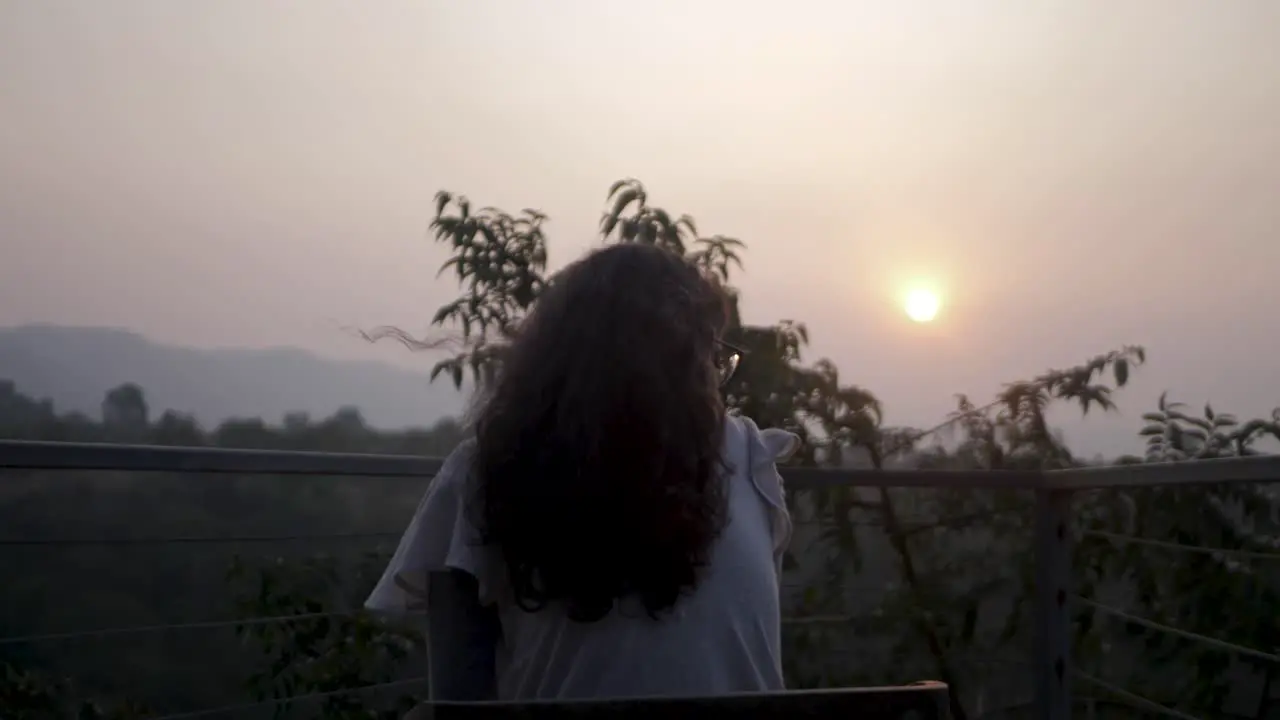 Beautiful girl enjoys a sunset view