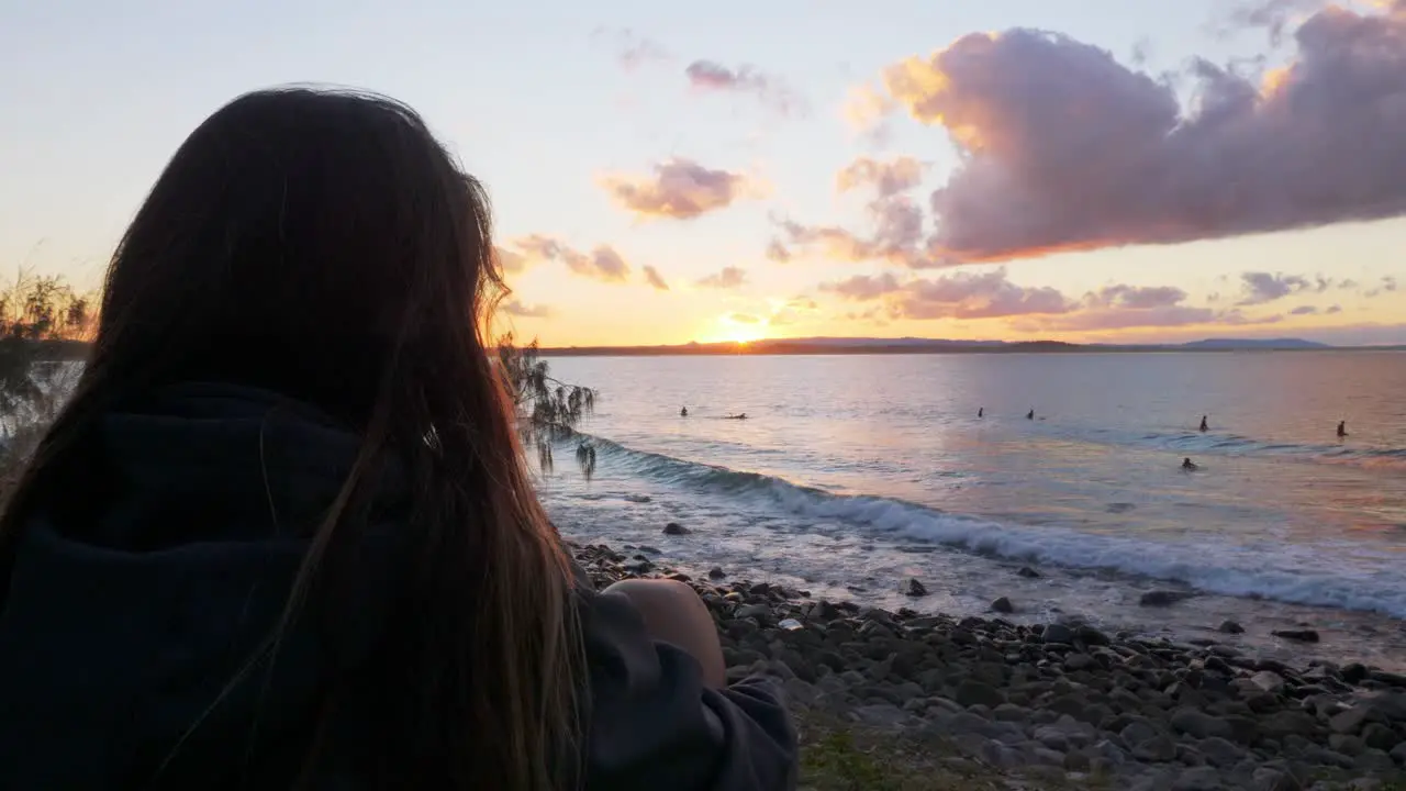 Woman Watching The Surfers At The Beach During Sundown In Noosa National Park In Australia