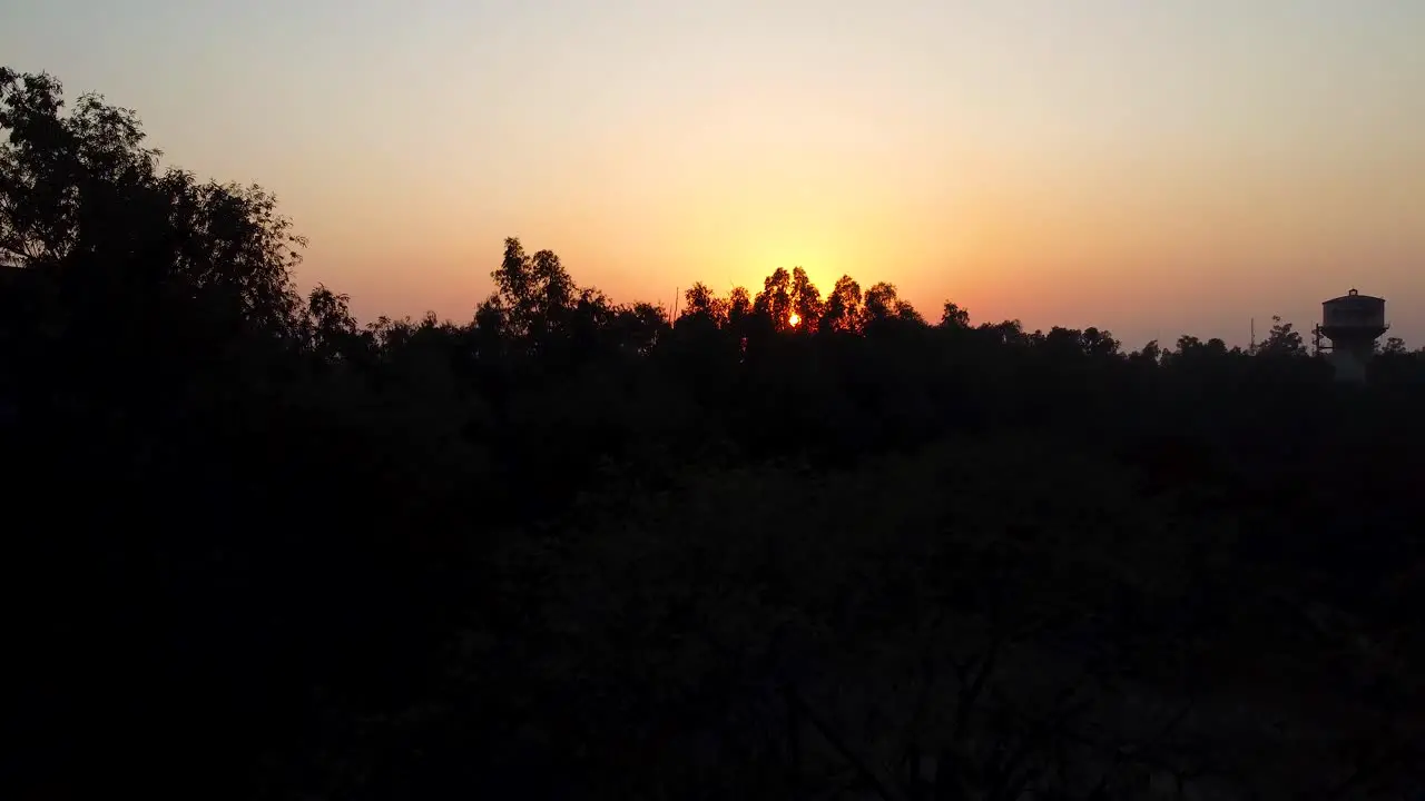 sunset orange colorful dramatic sky aerial view with tree shadow at evening