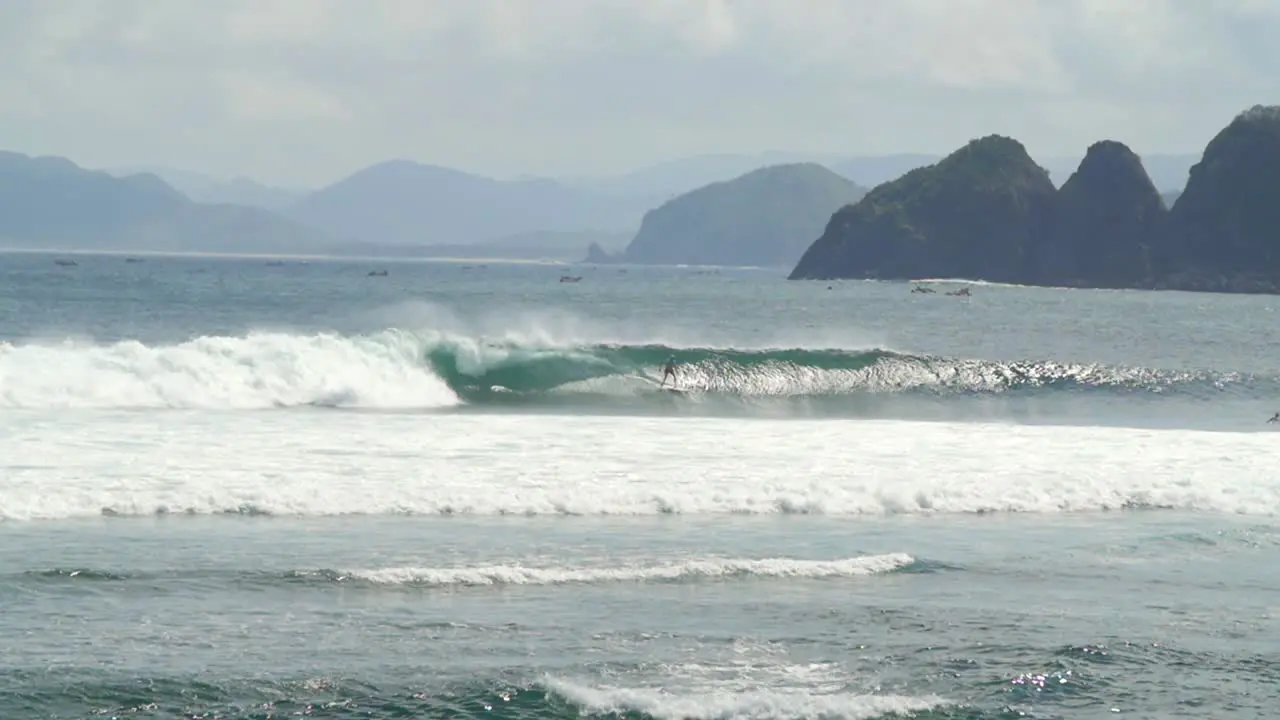 Surfer Surfing Past a Small Island