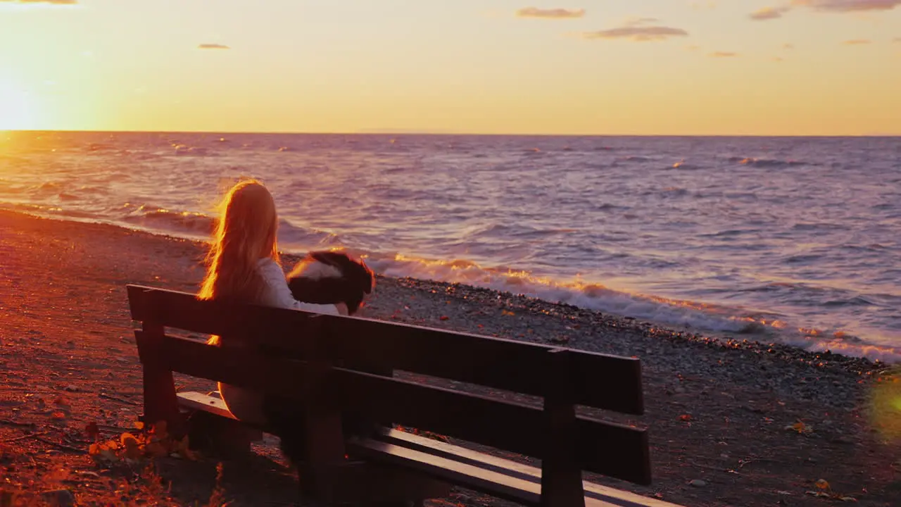 A woman rests with a dog on a bench 1