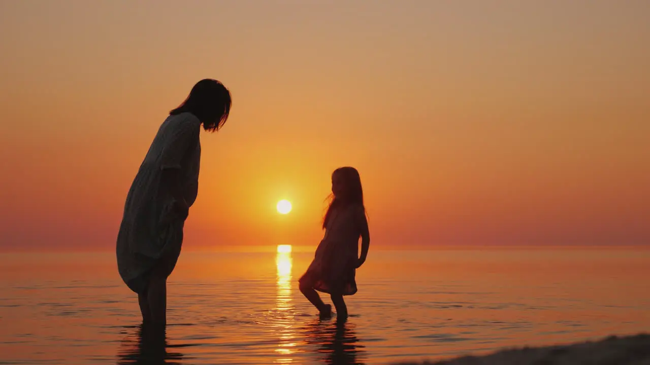 Pregnant Mother Having Fun With Her Eldest Daughter By The Sea Beautiful Sunset Waiting For The Seco