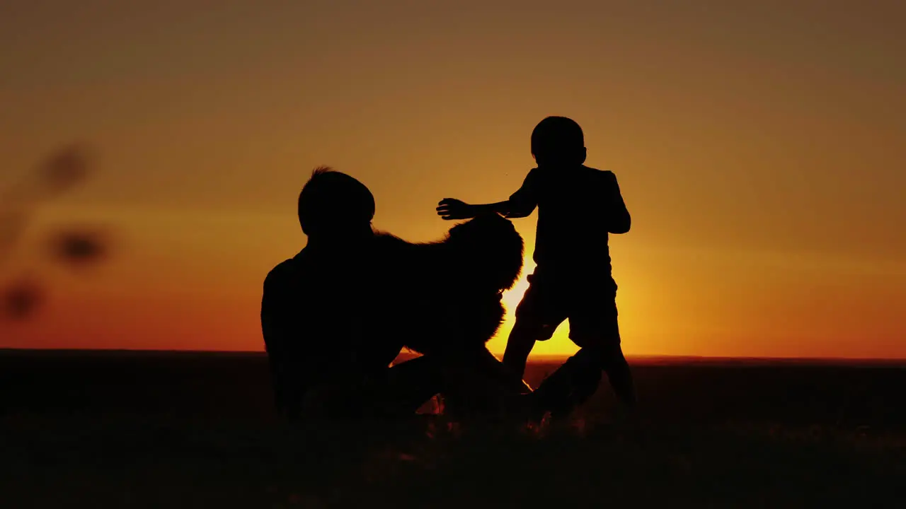 Two Boys Play With A German Shepherd Puppy At Sunset