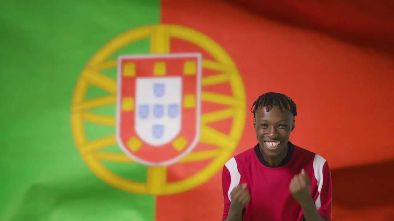 Young Footballer Celebrating to Camera In Front of Portugal Flag 01