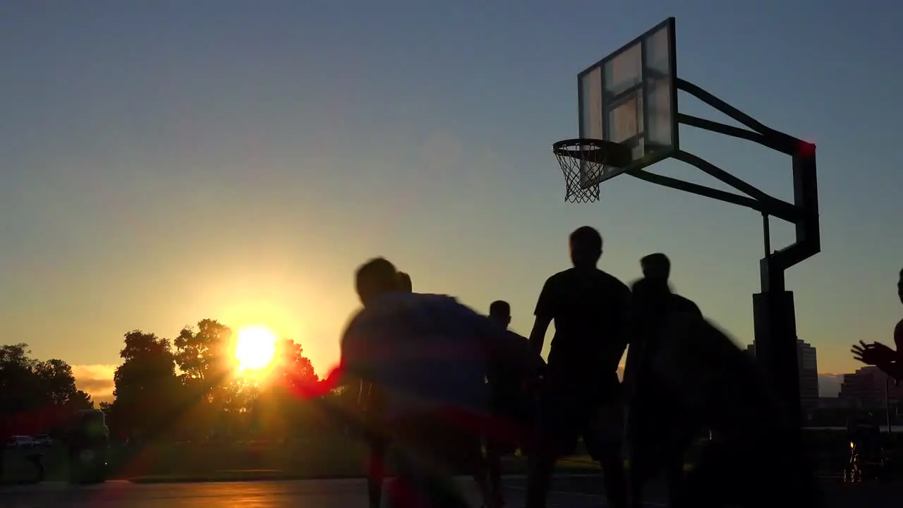 Teams play a pickup game at a local park at sunset 1