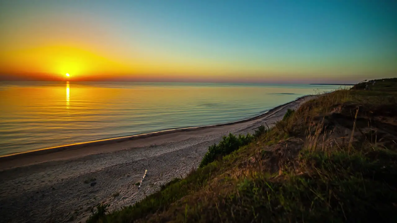 Time lapse of sunset over empty beach and ocean