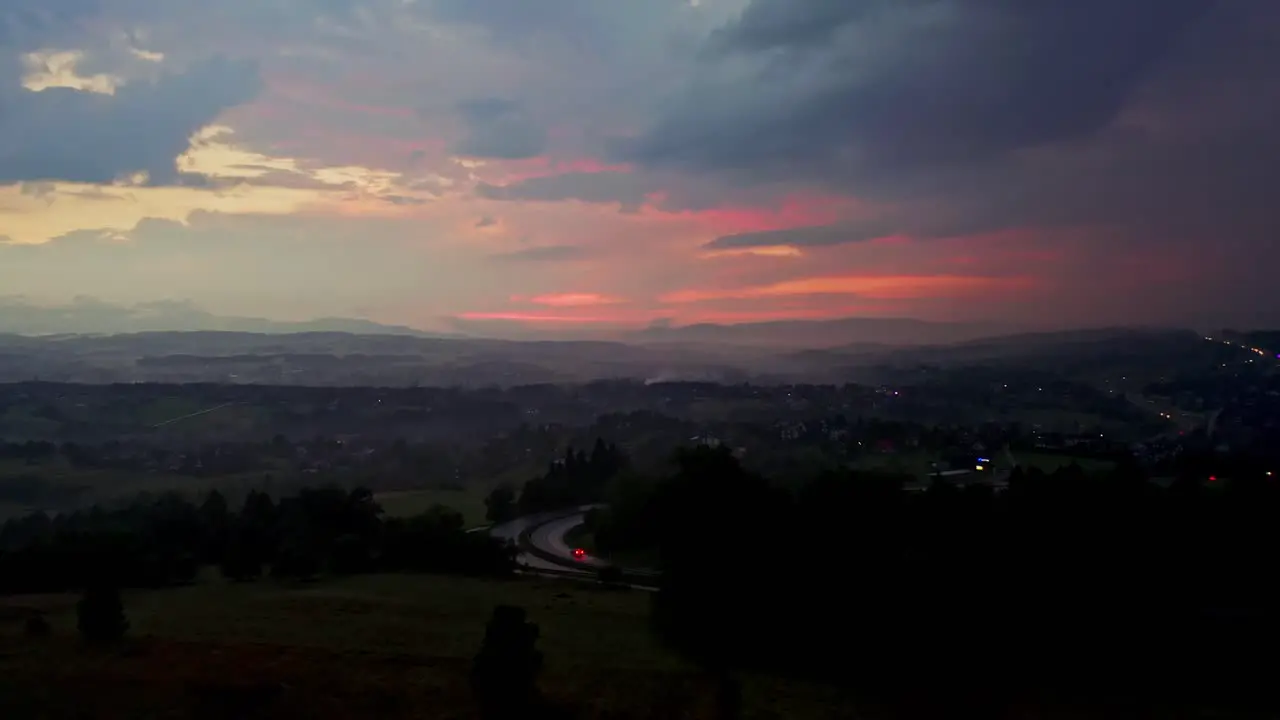 Cloudy Sunset Sky Before Storm Over Rural Road With Car Driving On Rainy Season