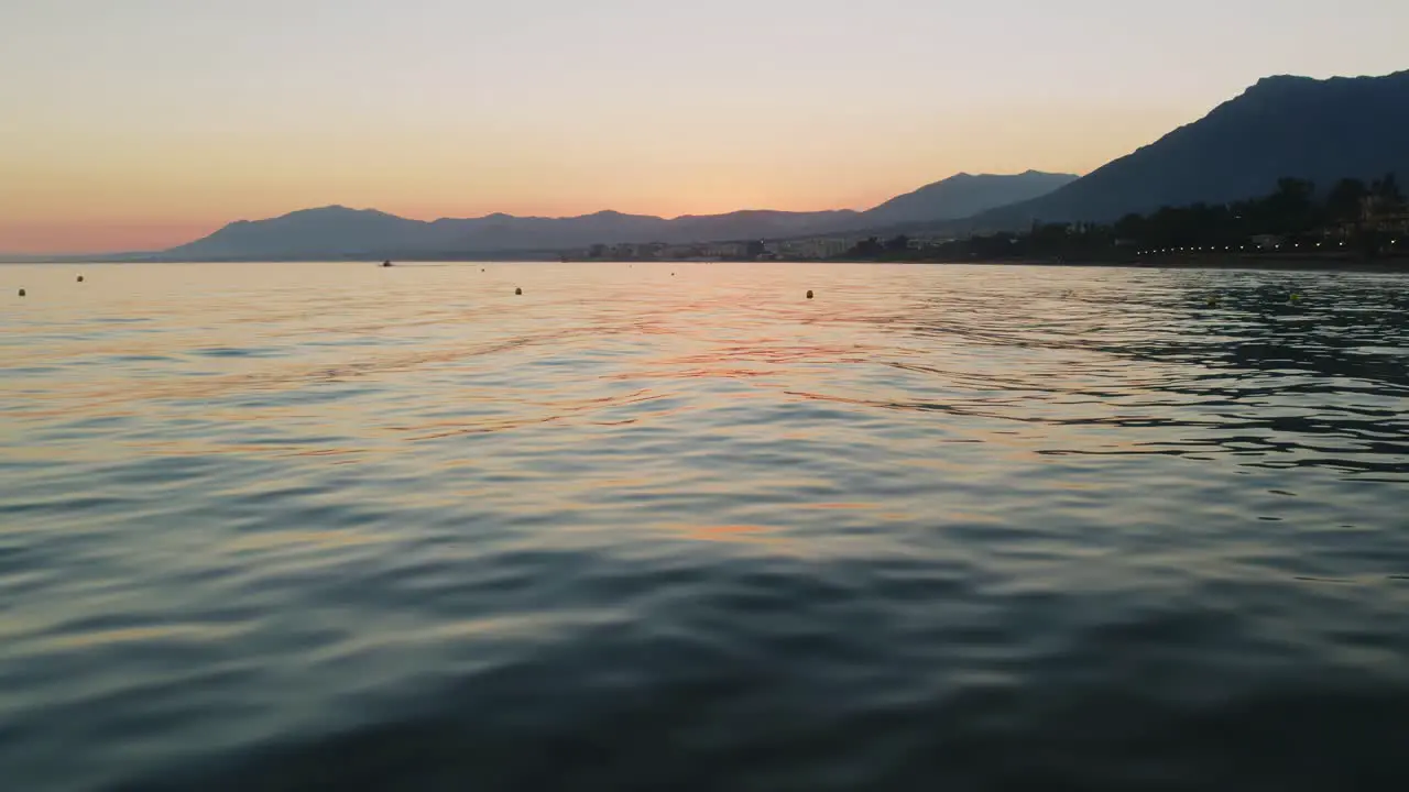 Drone flying over the calm water of the Mediterranean sea near Marbella Spain