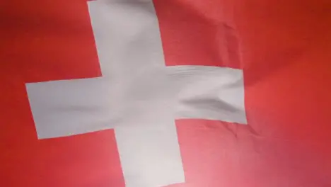 Close Up Studio Shot Of Swiss Flag Flying Filling Frame