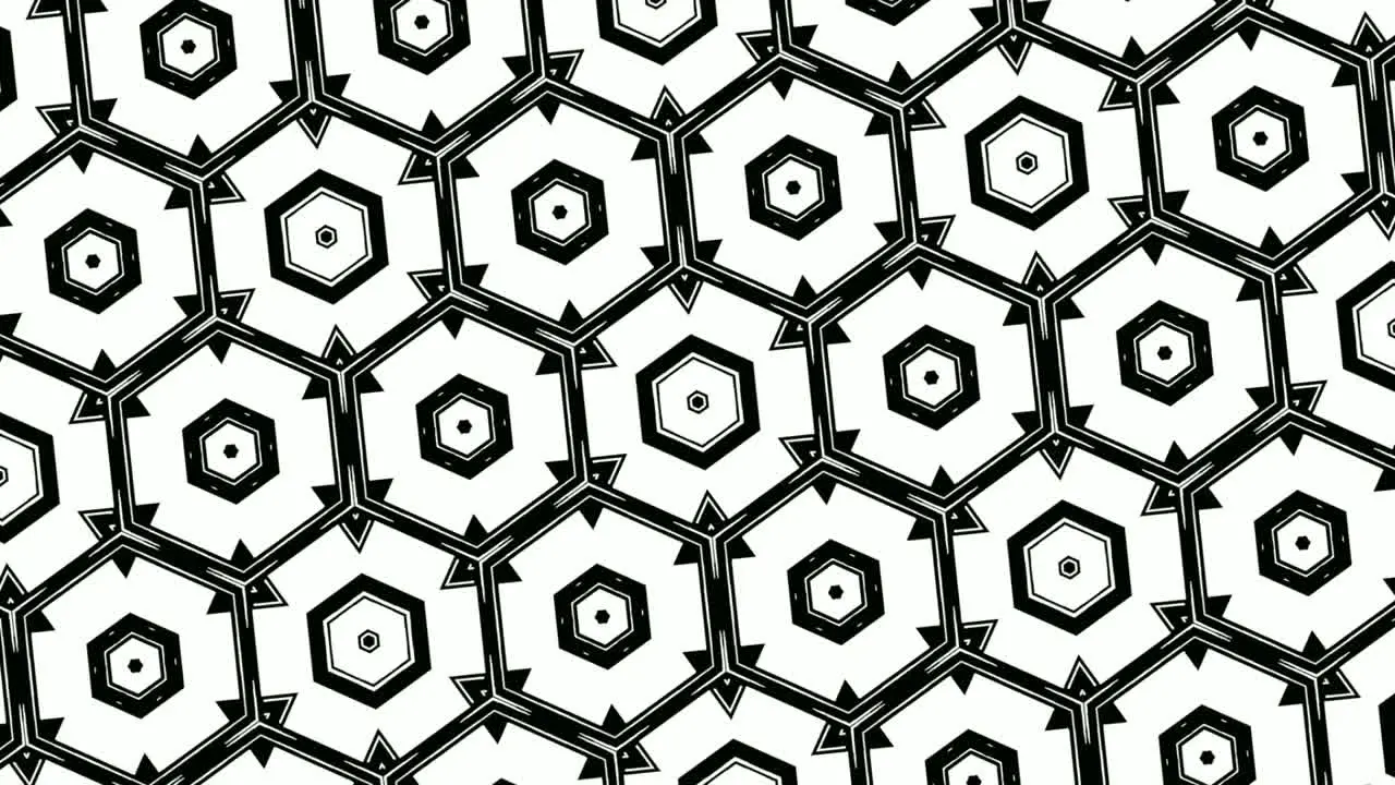 Animation of monochromatic design of hexagons arranged symmetrically in rows and revolving on white background