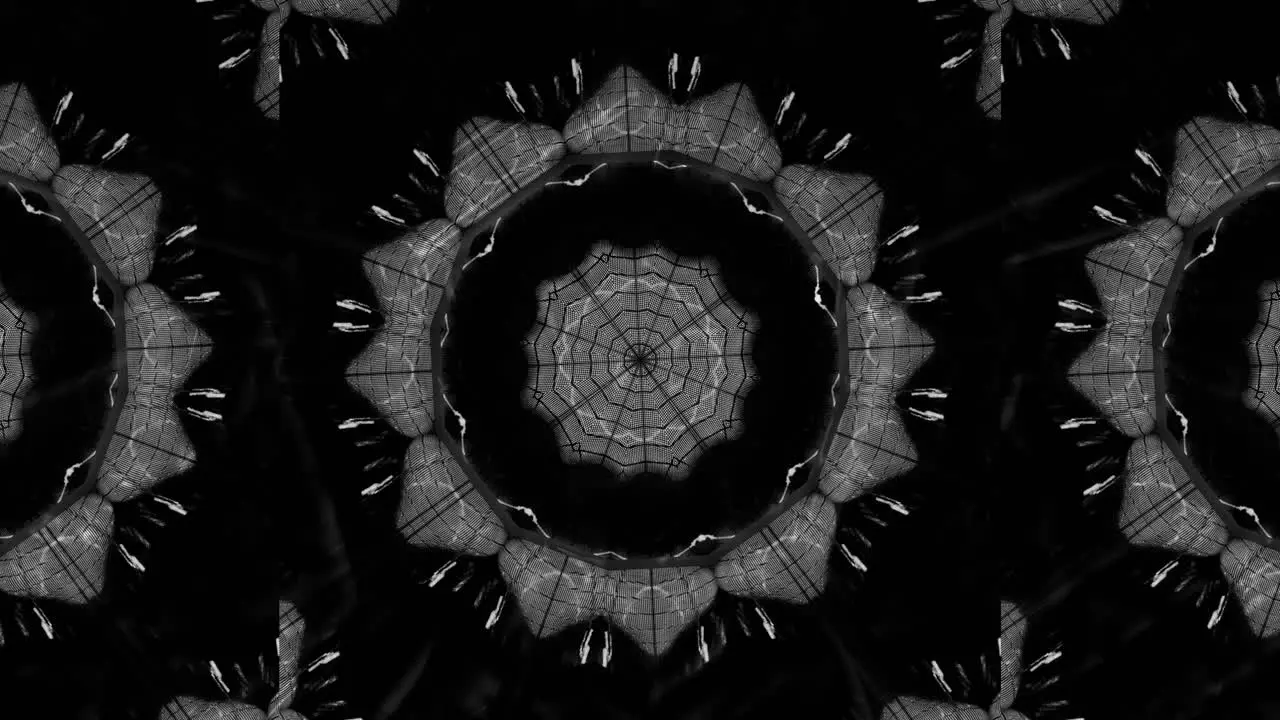 VJ Loop Glowing and Rotating Kaleidoscope Creating Random Geometric Patterns in White