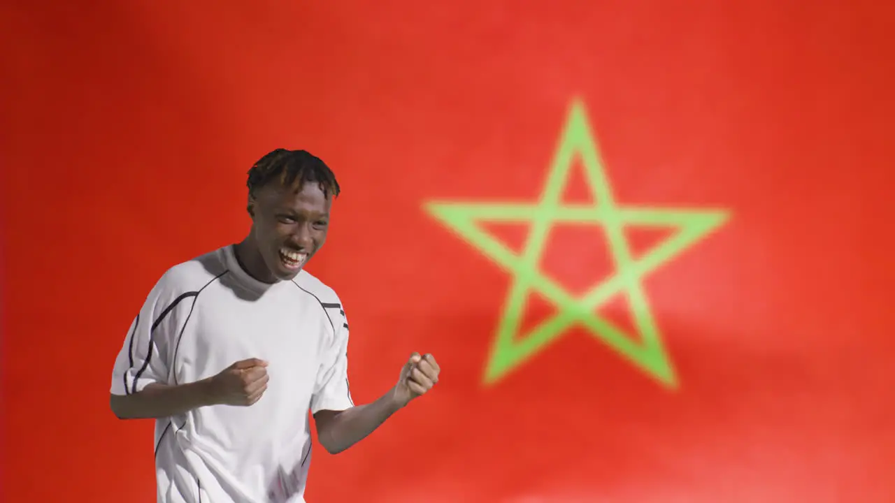 Young Footballer Celebrating to Camera In Front of Morocco Flag 02