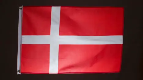 Studio Shot Of Flag Of Denmark Against Black Background