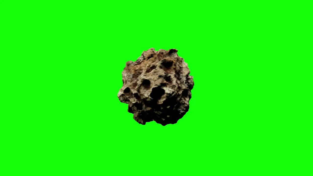 Brown-Grey Asteroid with notches and dents is passing by from Left to Right while spinning on Greenscreen