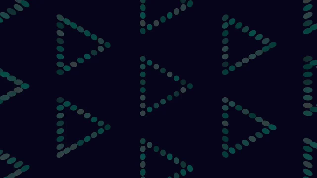 Dots of green create symmetrical triangle pattern on dark background