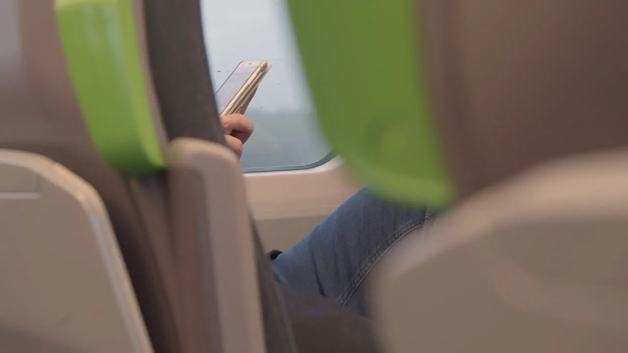 Man using phone on a train