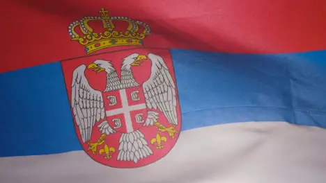 Close Up Studio Shot Of Serbian Flag Flying Filling Frame