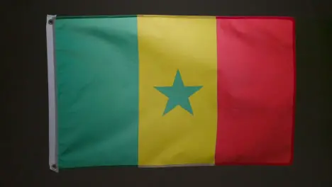 Studio Shot Of Flag Of Senegal Flying Against Black Background