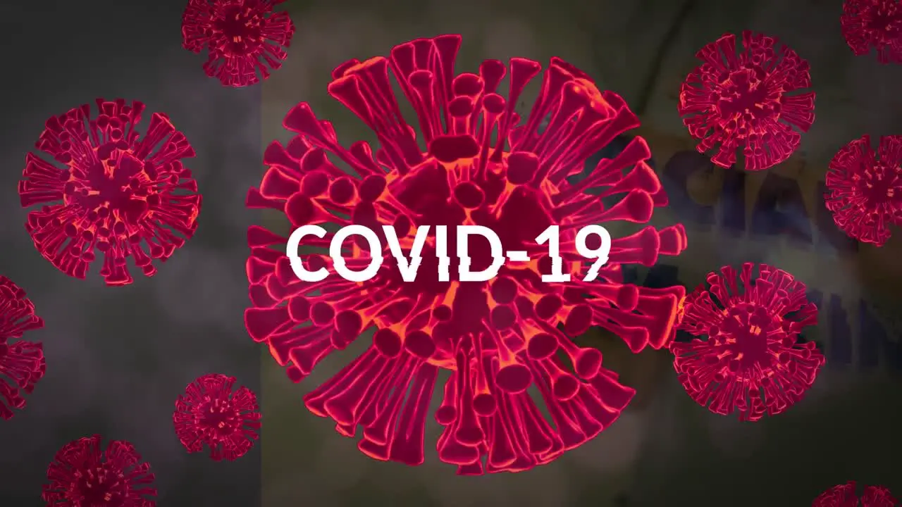 Animation of covid 19 text over multiple red virus cells