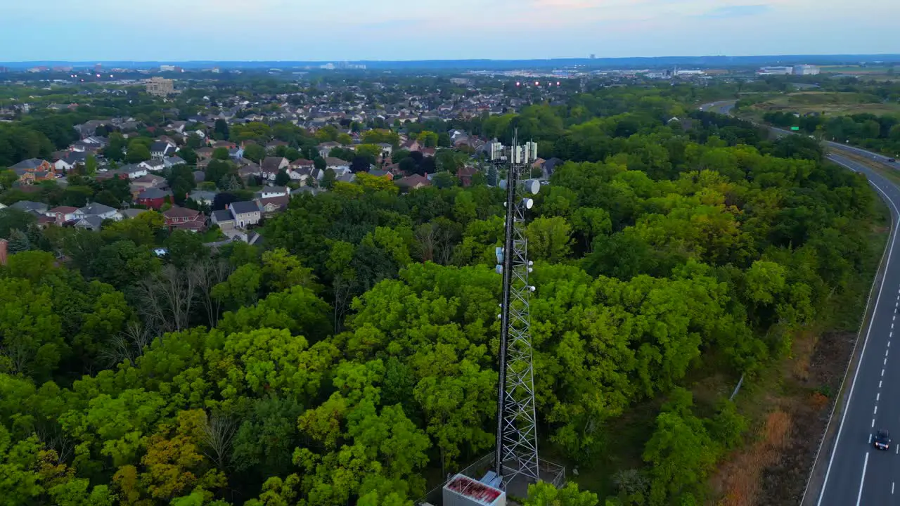 Orbital aerial view of cell phone tower close to neighbourhood