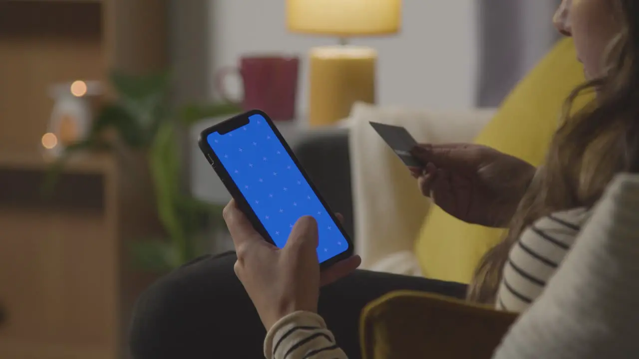 Close Up Of Woman At Home Shopping Online With Credit Card Using green screen blue Screen Mobile Phone 1