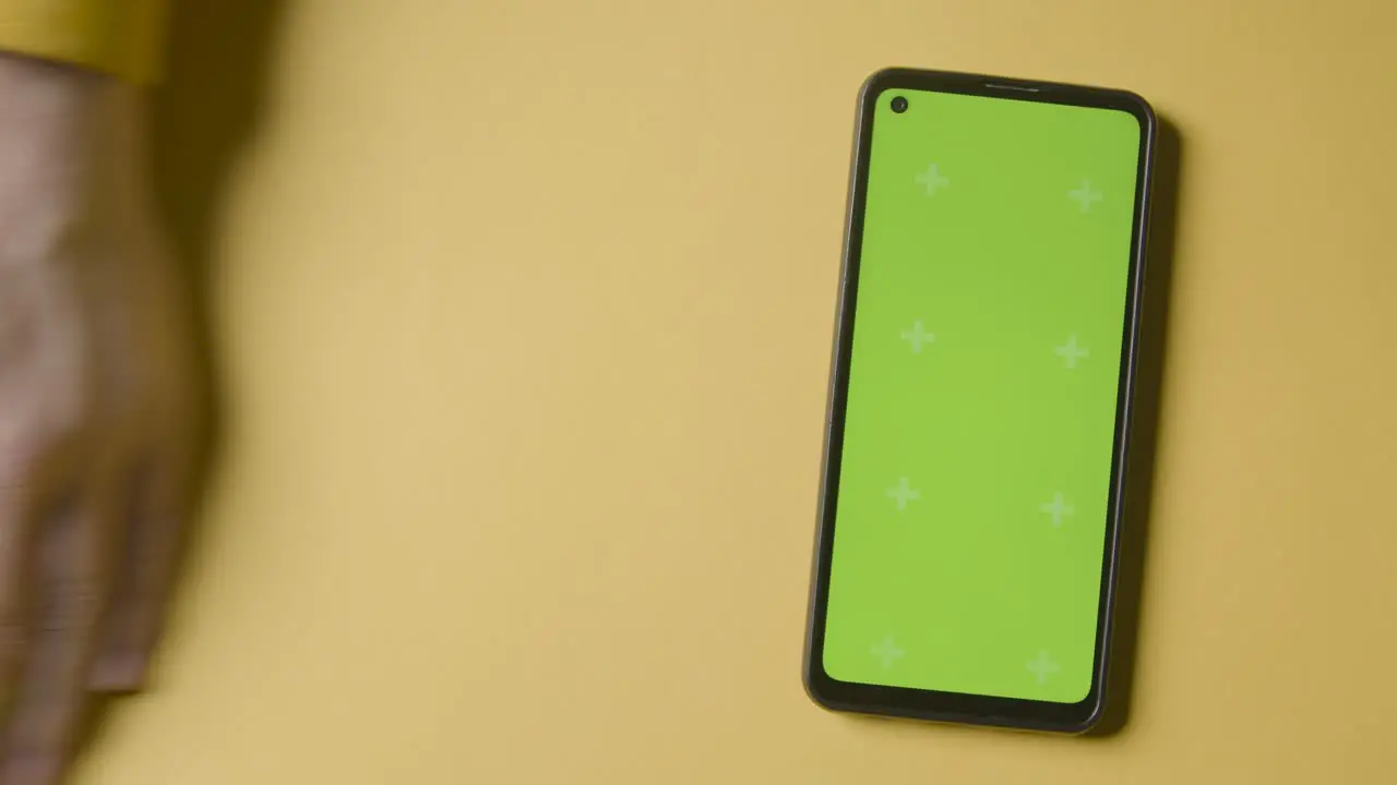 Studio Overhead Shot Of Plastic Numbers Arranged In Order With Green Screen Mobile Phone On Yellow Background 2