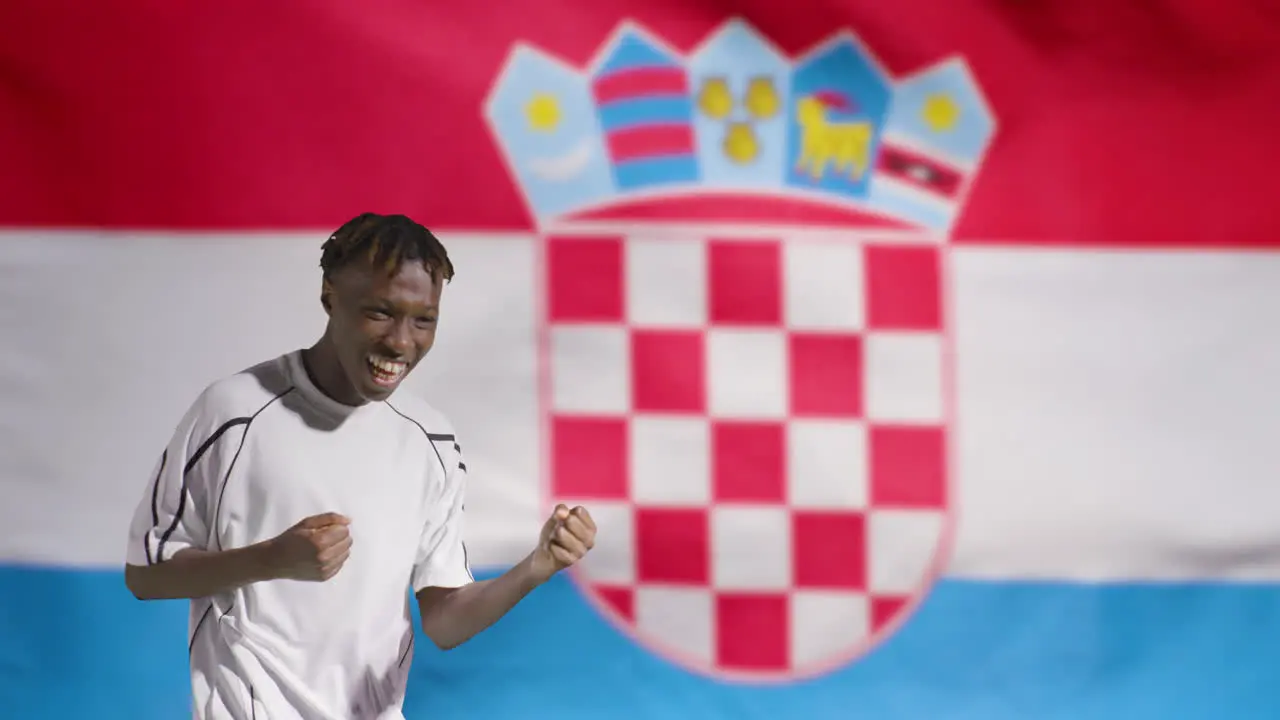 Young Footballer Celebrating to Camera In Front of Croatia Flag 02