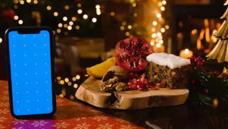 Christmas Food At Home And Traditional Christmas Cake And Blue Screen Mobile Phone