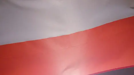 Close Up Studio Shot Of Polish Flag Flying Filling Frame