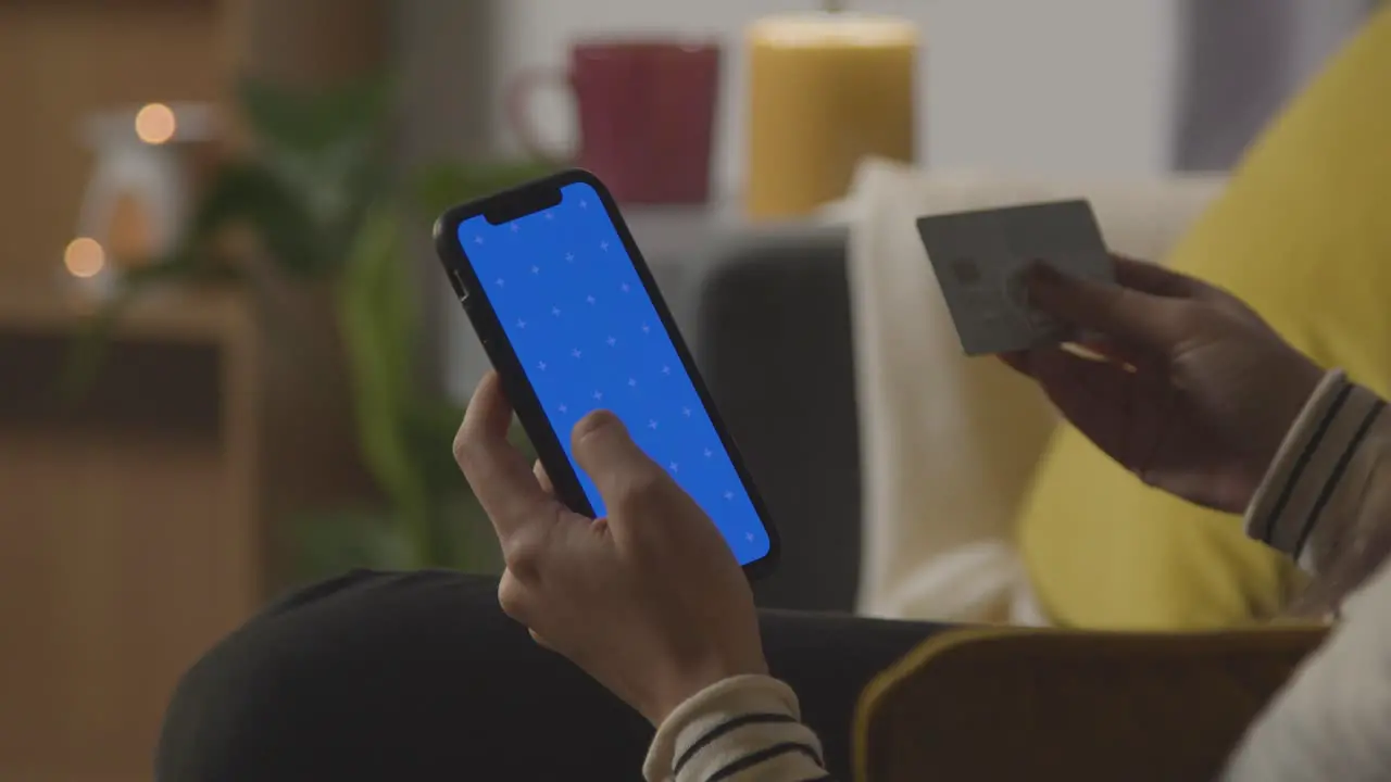 Close Up Of Woman At Home Shopping Online With Credit Card Using green screen blue Screen Mobile Phone