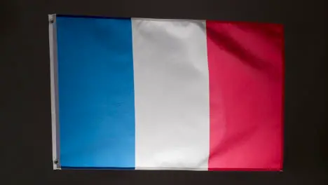 Studio Shot Of Flag Of France Flying Against Black Background