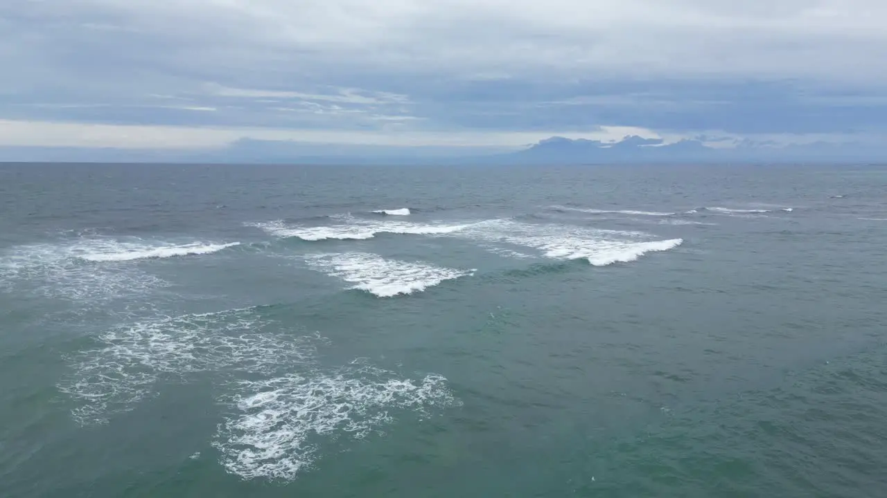 Small rippling waves out at sea off the coast of Uluwatu Bali