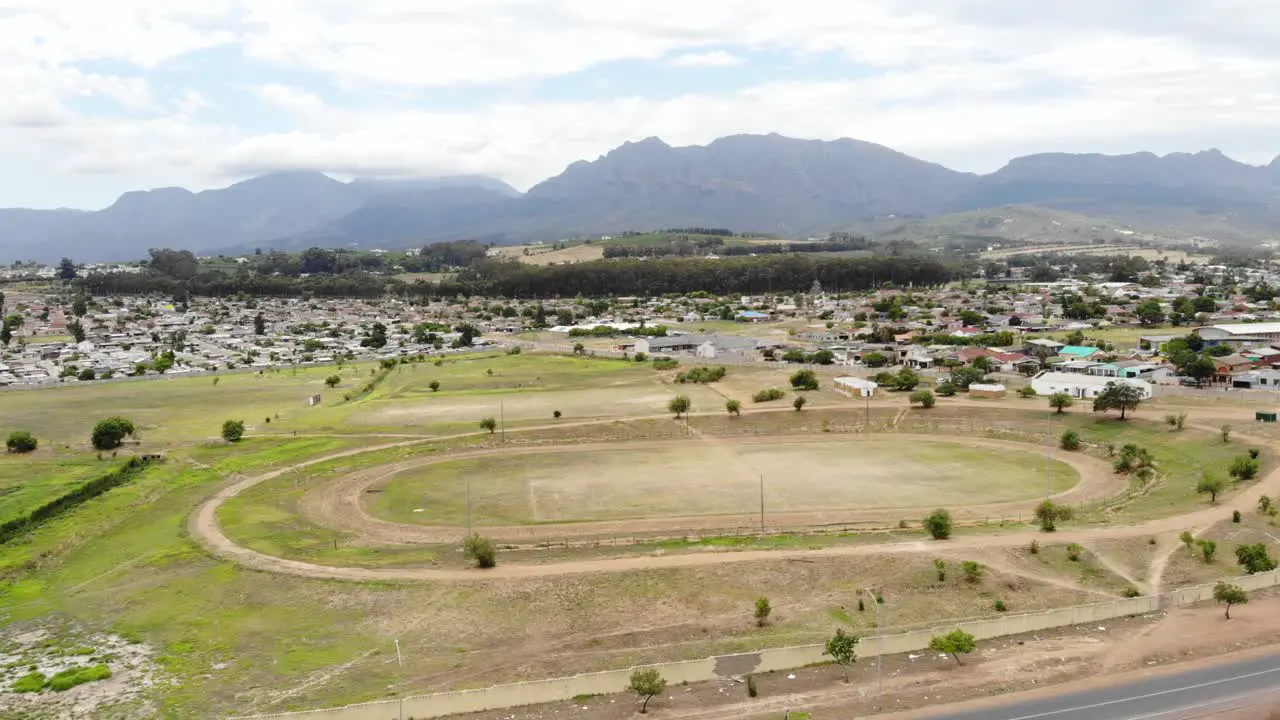 A drone shot of a township dirt athletics track in Paarl