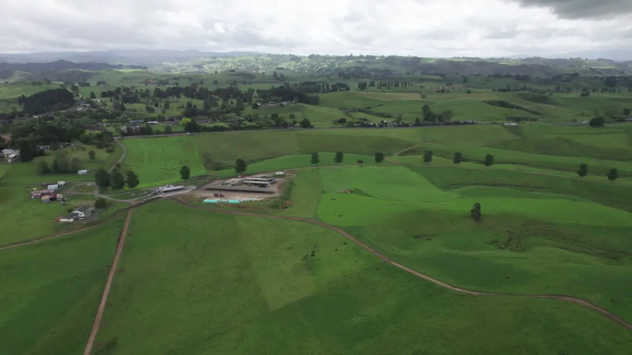 flying over green farmlands toward the road in Waikato North Island New Zealand