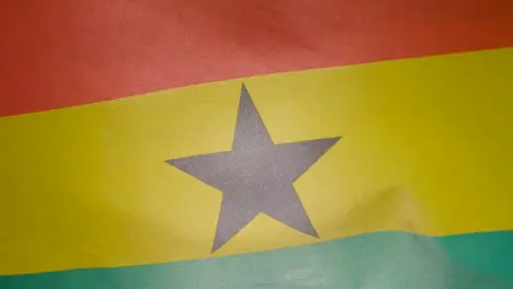 Close Up Studio Shot Of Ghanaian Flag Flying Filling Frame