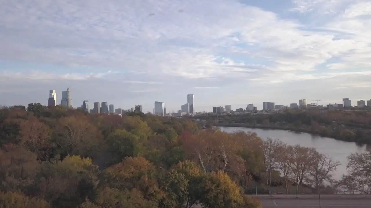 Drone Descending 4K Shot of Philadelphia Skyline to Highway During Autumn