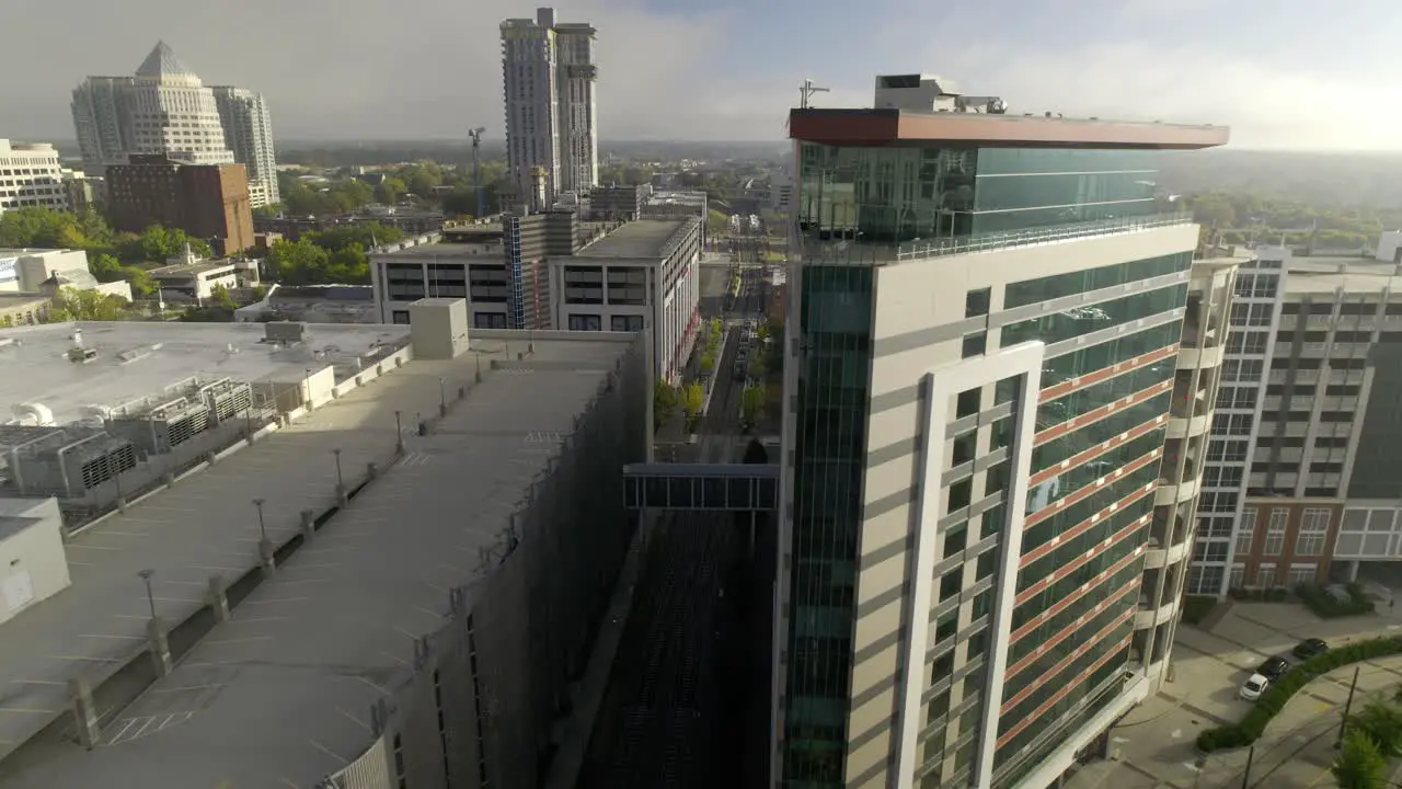 Drone flies along skyscrapers in the early morning in downtown Charlotte