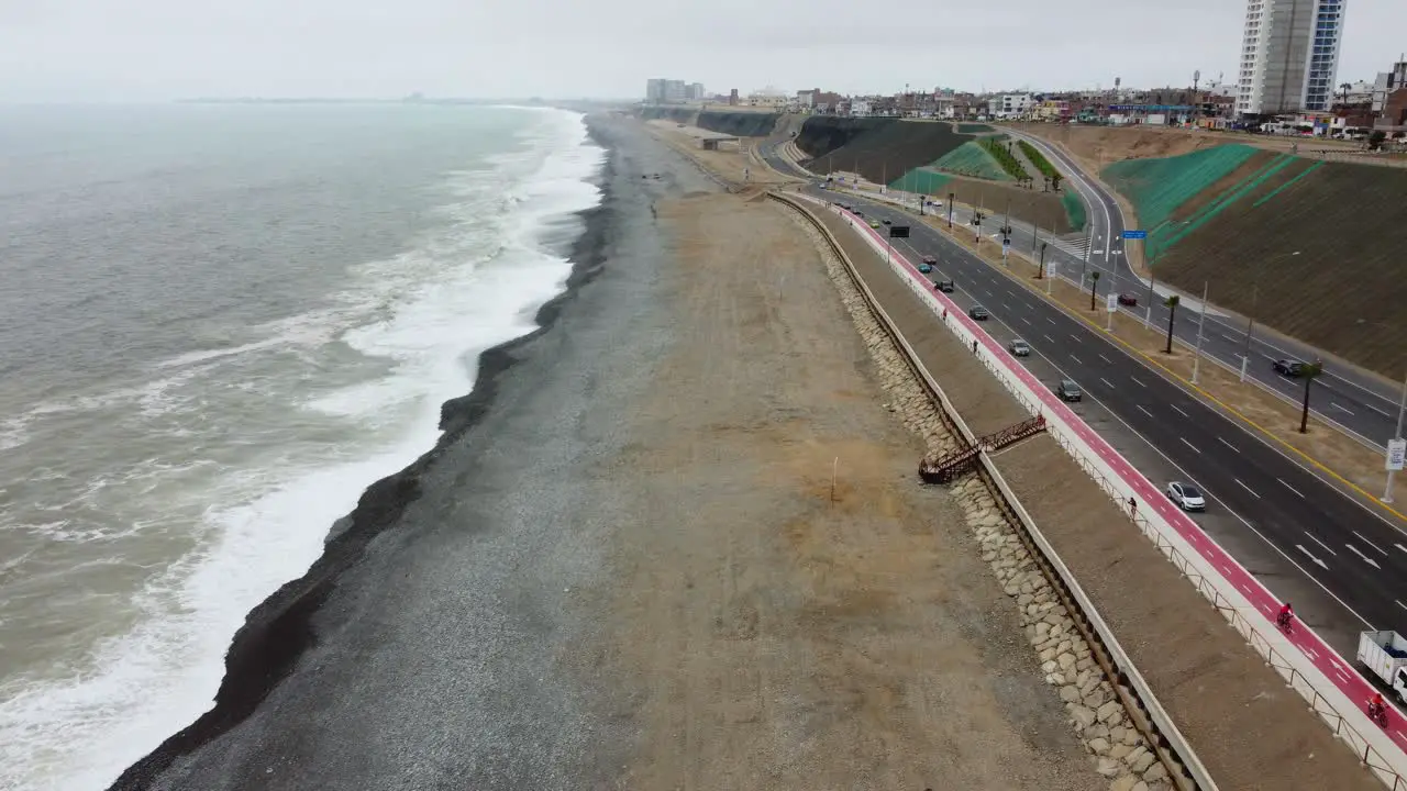 Drone footage of beach coast line and freeway next to it