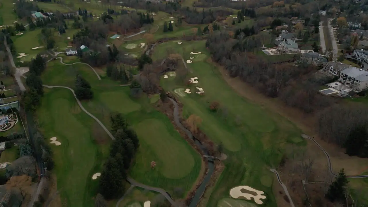 Aerial drone shot flying above a golf course and revealing a city horizon in Toronto Ontario Canada