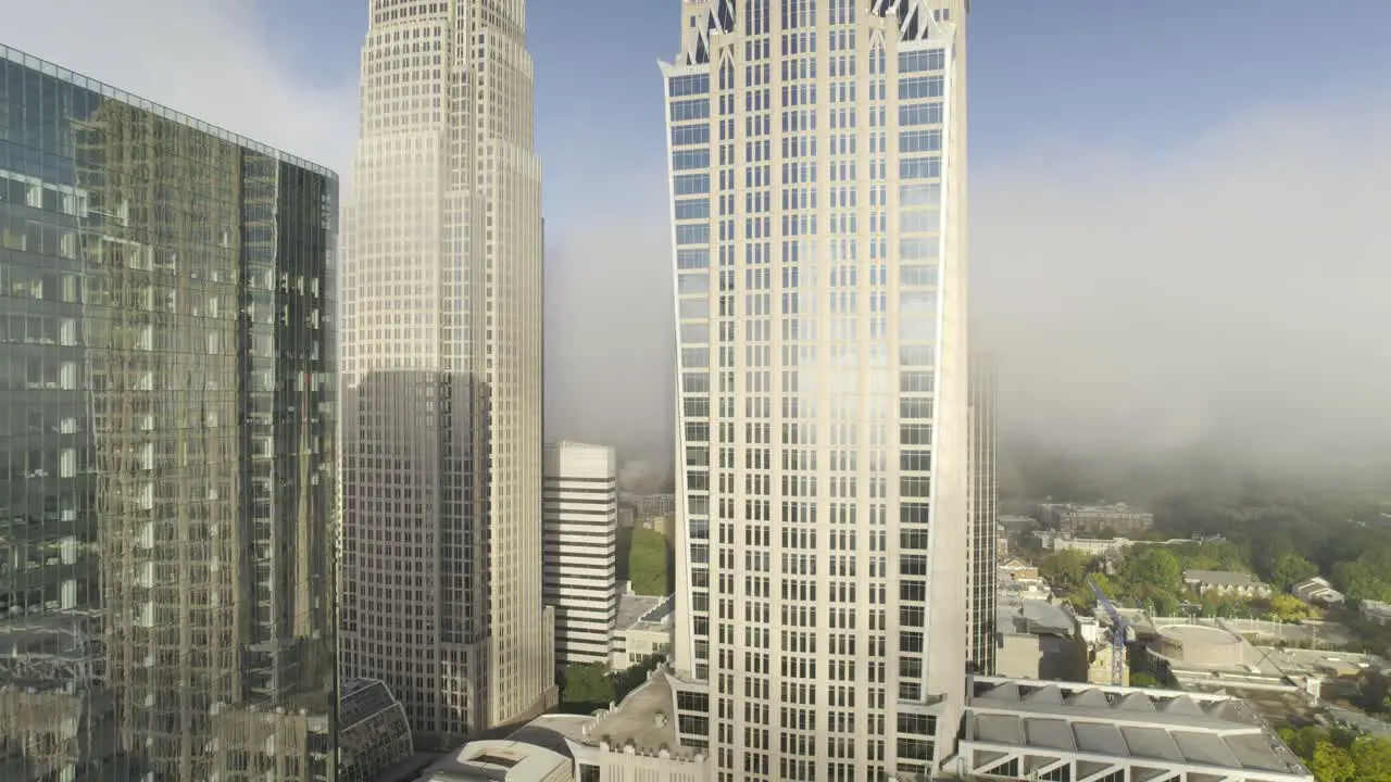 Clouds and Fog roll through skyscrapers in the early morning in downtown Charlotte