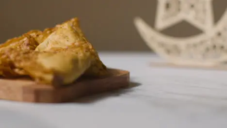 Samosas On Wooden Board Celebrating Muslim Festival Of Eid With Symbol Of Pakistan