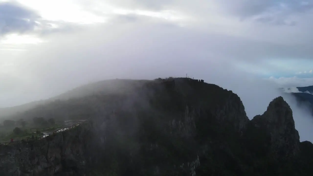 Drone footage of a mountain and crest on a cloudy day