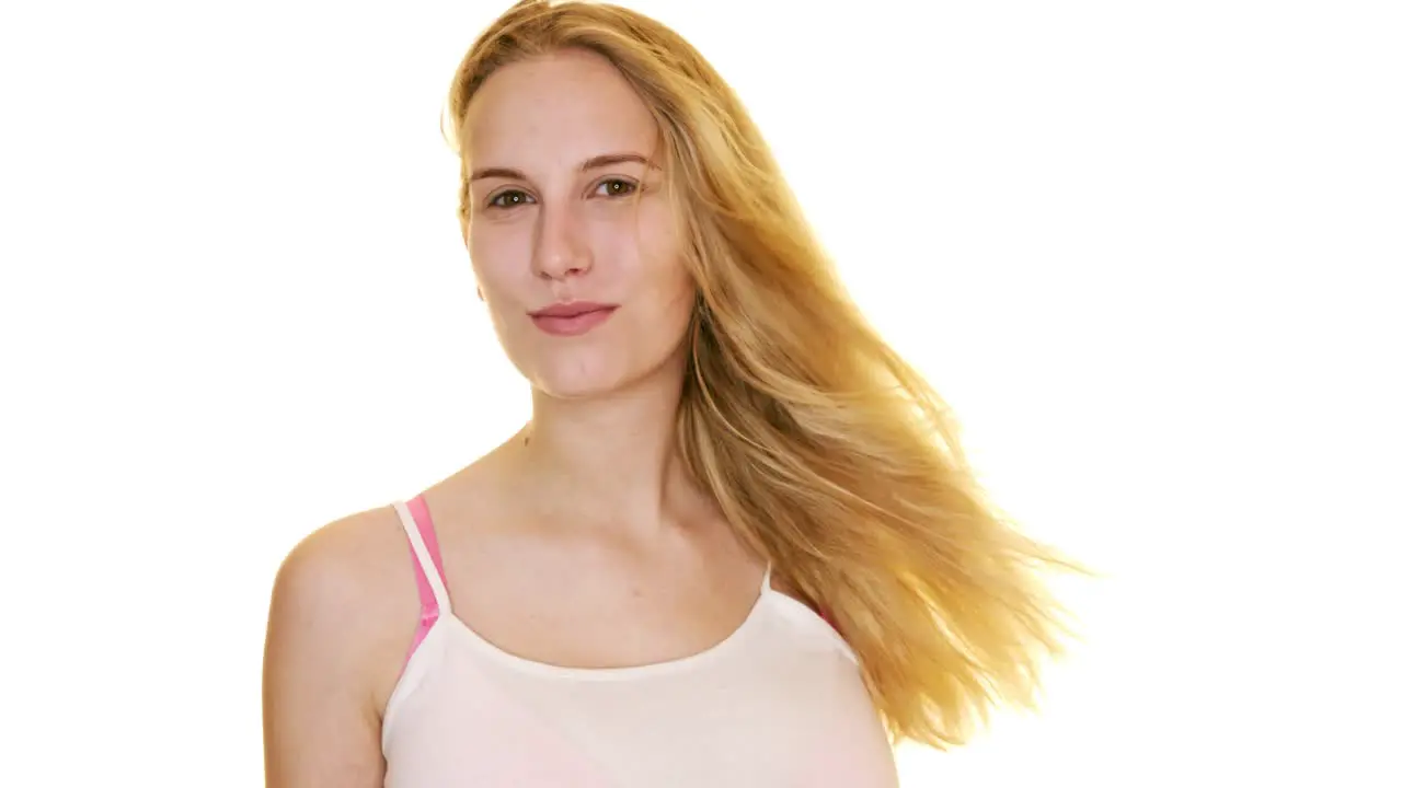 Slow motion portrait of beauty blond woman with healthy blond straight hairs waving by wind