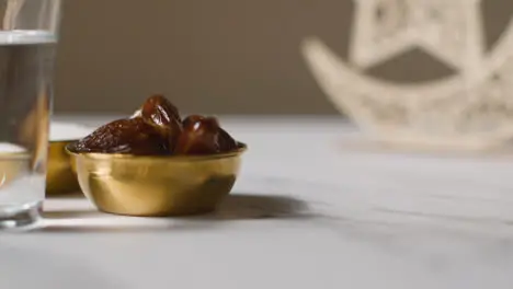 Bowl Of Dates With Sugar And Glass Of Water Celebrating Muslim Festival Of Eid With And Symbol Of Pakistan