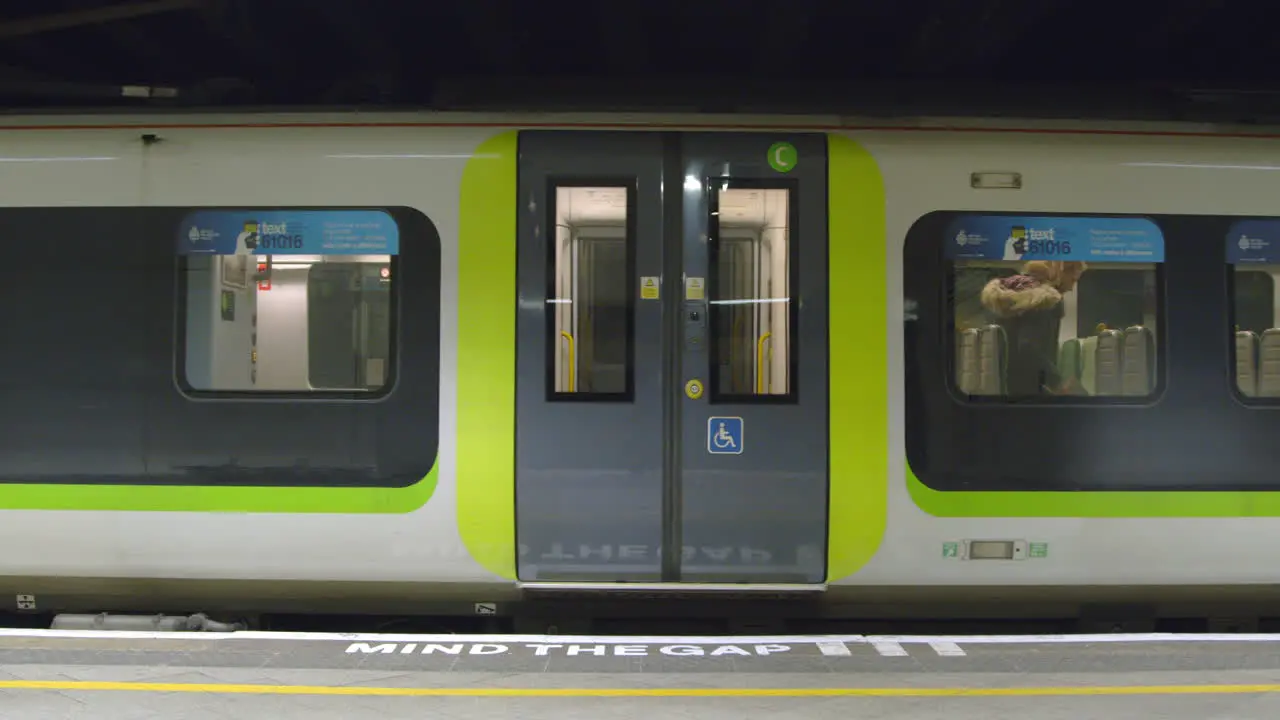 Woman walks door aisle as train leaves