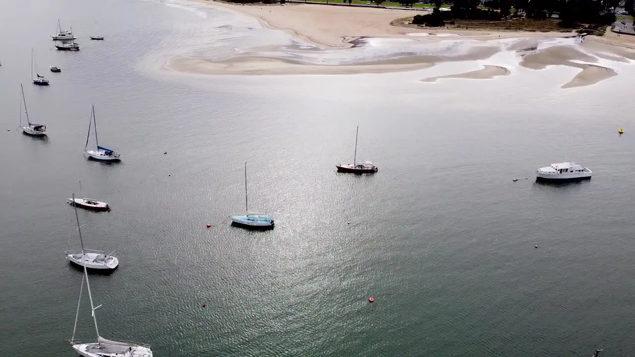 Aerial drone shot of boats anchored in harbor and city skyline Melbourne