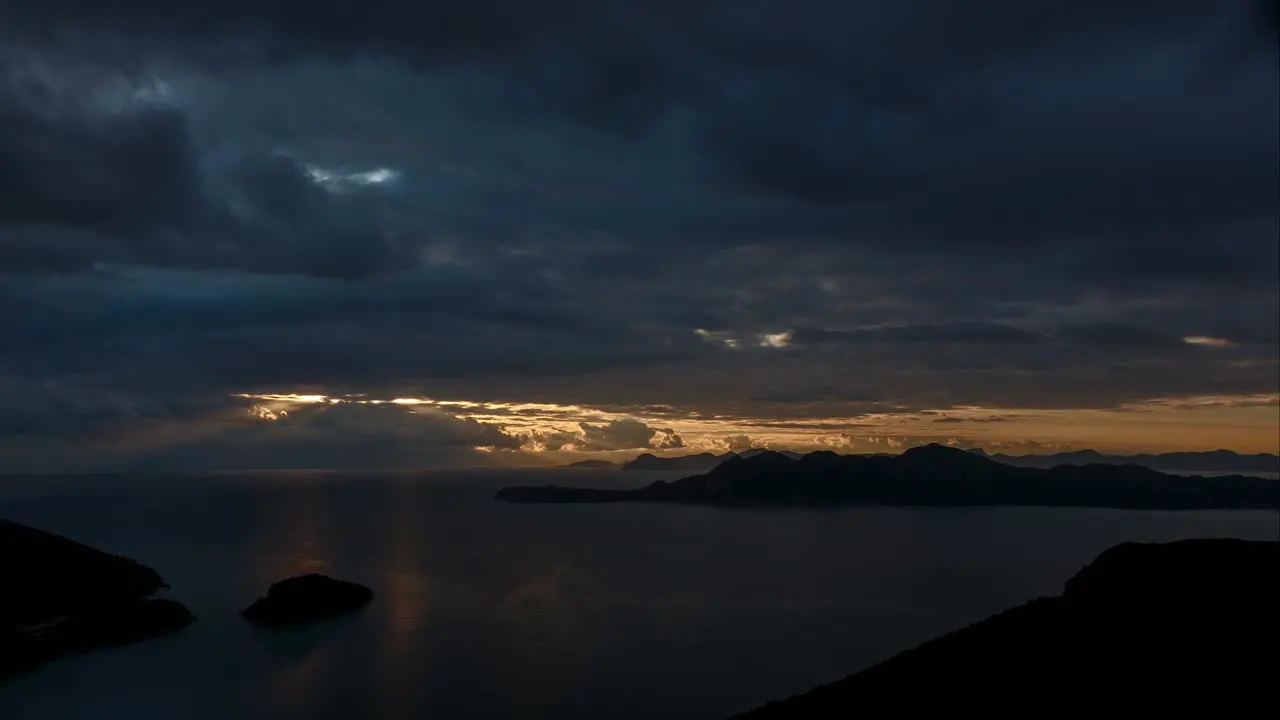 Stunning timelapse of shiny Sunlight beams penetrate clouds to reflect on Sea water near Mallorca island