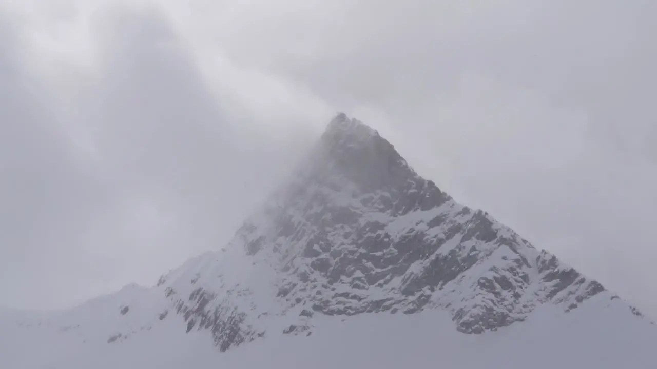 Wind whipping over rocky mountain summit in winter